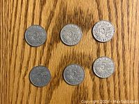Six 1932 Canadian nickels showing the reverse sides with '5 cents', maple leaves, and 'Canada'