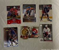 Six Wayne Gretzky hockey cards displaying front artwork including various action poses and commemorative themes.