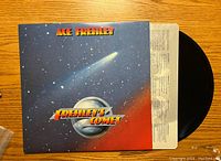 Front cover of vinyl album 'Frehley's Comet' showing space theme with comet and metallic logo text.