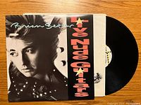 Front of vinyl record and sleeve featuring close-up portrait of Brian Setzer with text.