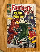 Front cover of Fantastic Four issue #60 comic book showing vivid fight scene between The Thing and Doctor Doom with other Fantastic Four members.