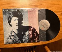 Front cover of George Thorogood and the Destroyers Maverick album with vinyl partially visible.