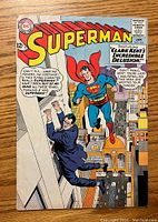 Front cover of Superman #174 comic book with Superman holding a man over a city.