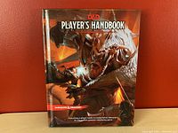 Front cover photo of the Dungeons and Dragons Player's Handbook showing the title and detailed fantasy artwork.
