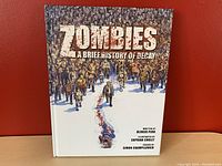 Front cover of the graphic novel showing the title and illustrated zombies walking towards the foreground.