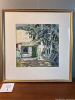 Framed watercolour painting hanging, showing overall appearance of frame, mat and glass