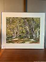 Frontal view of framed watercolor landscape painting depicting forest scene