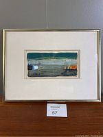 Photo of the full framed artwork showing the abstract painting with a gray mat and metal frame.