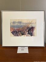 Framed original watercolour painting on paper by Pat Fairhead depicting trees with muted purple, orange and gray tones. The frame is metal with glass and measures 13" x 12".