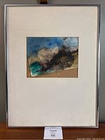 Full view of framed painting showing white matting and silver metal frame with glass, painting is somewhat shifted in the frame.