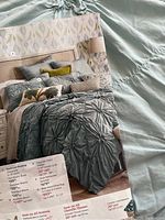 Duvet cover and sham pillow with Pier 1 Savanna bedding promotional flyer showing same bedding set and pricing details.