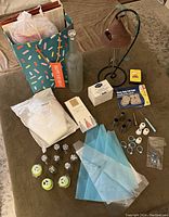 Full lot showing cake decorating items including piping tips, icing bags, food coloring, gift bags, felt pads, glass bottle, and solar chime.
