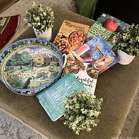 Overview of 5 cookbooks, 1 decorative Emma Bridgewater tray, and 3 IKEA artificial potted plants