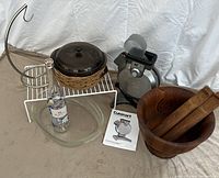 Full lot showing all items including teak bowl, waffle maker, banana stand, casserole dishes, wine bottle, and shelf rack