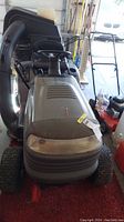 Front view of Craftsman LT1000 riding mower showing gray hood, steering wheel, and attached catcher basket at the rear.