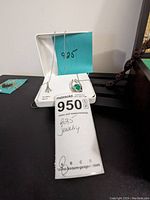 Two .925 sterling silver necklaces displayed on a white jewelry holder with a note indicating '925 jewelry'.