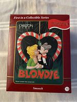 Front of the box showing the Blondie ornament titled 'Smooch' featuring Blondie and Dagwood in a candy cane heart frame