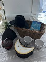 Overall shot showing all items from the front with natural light, contents inside basket and items arranged around it on white cloth.