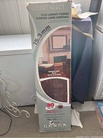 Front of the box showing brand, style, thickness (15.3mm), and coverage area (21.13 sq ft).