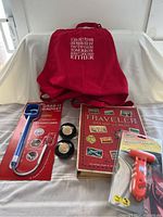 Lot showing all items: BBQ apron, stamp album, emergency hammer, grab-it gadget, coins