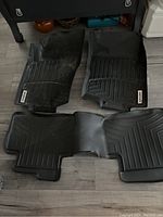Overview photo of four WeatherTech rubber floor mats including front driver and passenger mats and two rear mats connected as one piece.