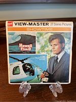 Front side of the View-Master box showing the Hawaii Five-O Showtime 21 stereo pictures title, images of helicopter and main character.