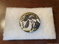 Front of vintage Bruce Springsteen tour pin showing photo and text