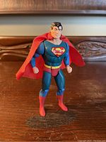 Front view of the 1984 Kenner Superman action figure showing blue suit, red boots, and original red cape.