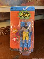 Front view of the sealed Batman action figure showcasing the figure in swim shorts.