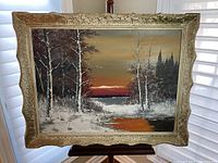 Front view of framed winter landscape painting