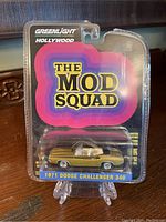 Front view of sealed packaging showing 'The Mod Squad' logo and 1971 Dodge Challenger diecast model.