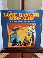 Front cover of vinyl record jacket showing title The Lone Ranger Rides Again with colorful illustration of Lone Ranger, horse, and Tonto.