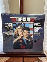 Front cover of Top Gun soundtrack vinyl showing main actors and title graphic.
