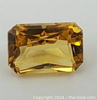 Front view of the rectangular faceted citrine gemstone showing color and clarity.