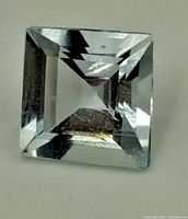 Top view of the colorless square-cut gemstone showing faceted crown and brilliance.