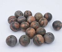 Eighteen round jasper beads with earth-tone coloring and drilled holes, displayed on white background.