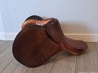 Side view showing the outer leather flap and brass rivets on Barnsby saddle.