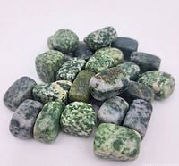 Photo showing a collection of about 20 moss agate jade beads with various green and white patterns.