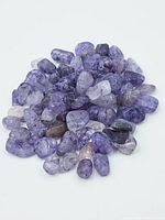 Overview photo showing the full collection of tumbled purple agate stones.