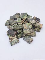 Photo of multiple rectangular serpentine beads showing natural green and black marbled patterns, used condition.