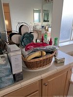 Basket with various bathroom items including shoe inserts and bottles.