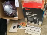 Cook's Essentials air fryer in eggplant color, recipe book, manual, and receipt for RCA TV visible in box