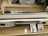 Photo showing 3 boxed BodyBlade workout equipment with exercise guides and DVDs inside boxes.