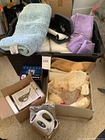 Full shot of the lot showing Conture facial device, towels, Panasonic cordless phone, and the My Little Steamer in box.