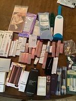 Full overview of the lot spread on table showing cosmetics, dental items, brushes, and accessories