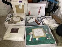 Lot overview showing all items including hair dryer, sheet sets, and gift sets