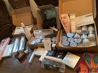 Wide shot showing multiple skin care and cosmetic items in boxes and laid out on table