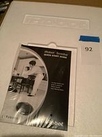 Original packaging of iRobot Scooba vacuum with quick start guide visible on top of the styrofoam tray.
