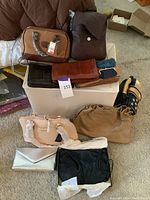 Full lot overview showing 10 purses and coin purses in various colors and styles, mostly leather, some wrapped in protective paper.