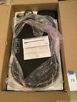 View of Rock Solid whole body vibration fitness machine packed in box, showing the platform and receipt.
